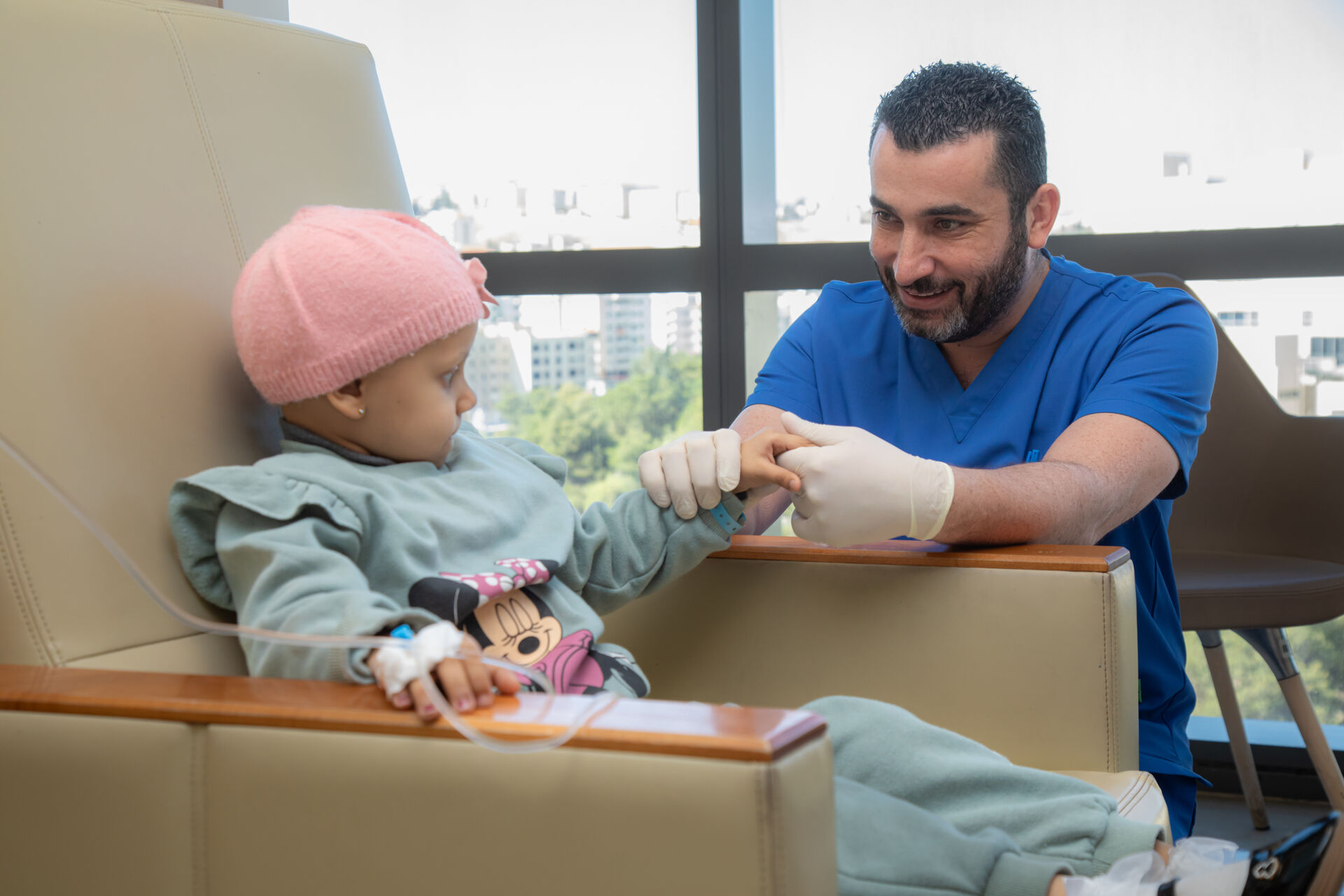 Doctor holds young patients hand